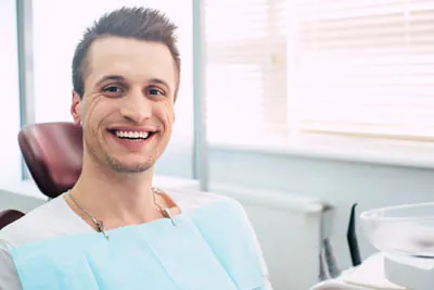 man smiling big during his dental exam at Stonebriar Family Dentistry in Frisco, TX